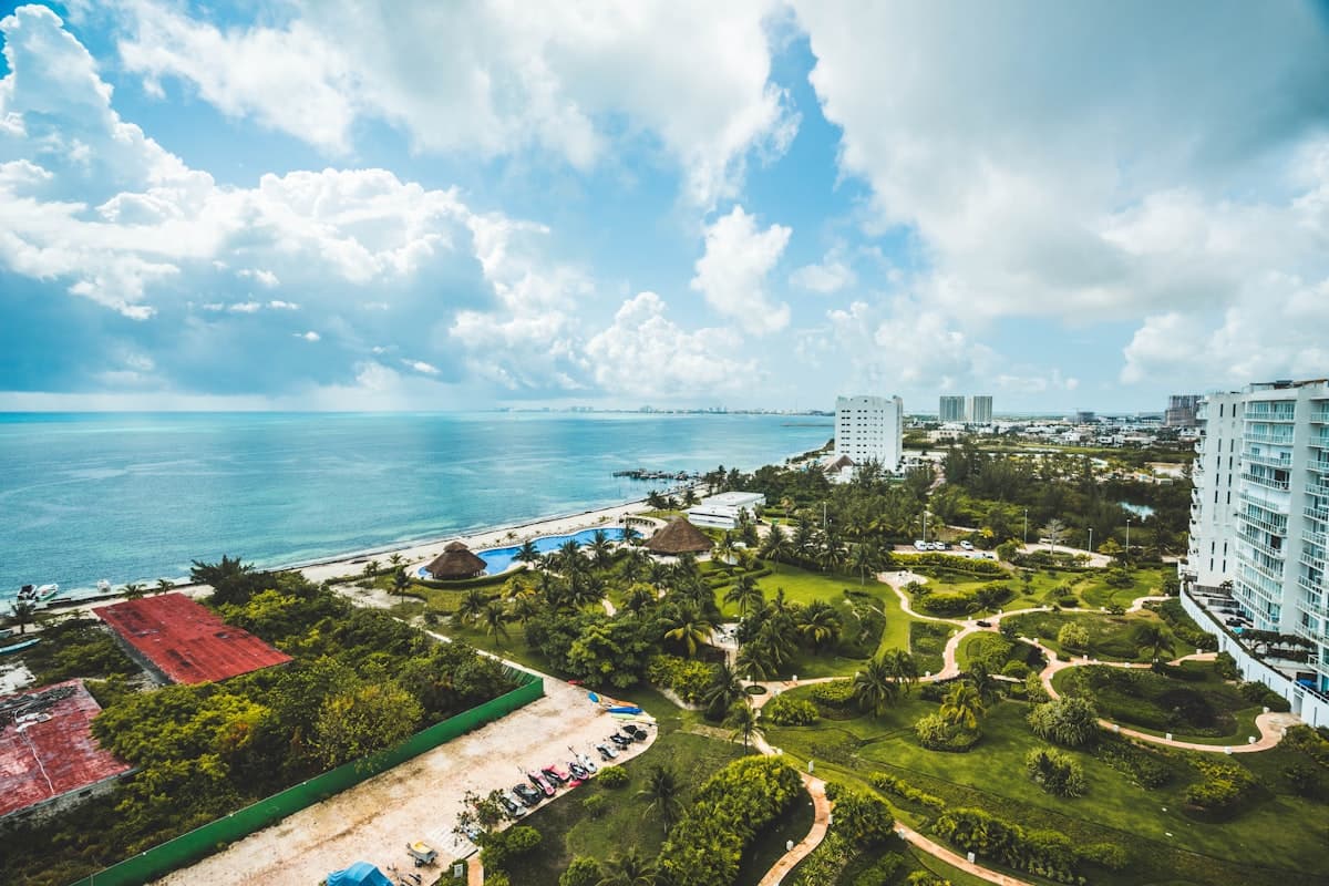 Aerial view of a turquoise Riviera Maya coastline with gardens and a resort